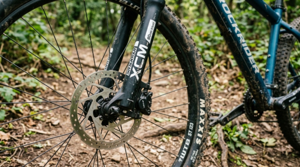 Close-up of disc brakes and suspension fork on an affordable hardtail mountain bike